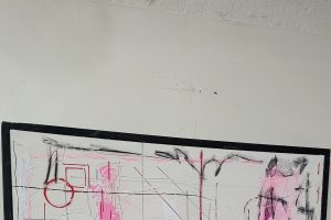 pink grey and white art on wall
