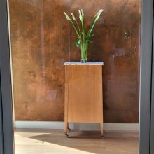 vase of flowers on a cabinet in the hallway