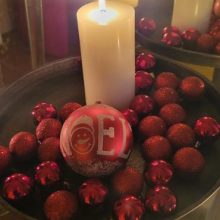 Candle with ornaments in a tray