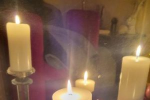 Candle with ornaments in a tray