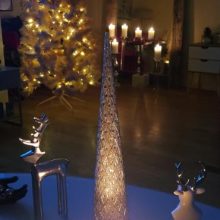 candle with decorations and a christmas tree