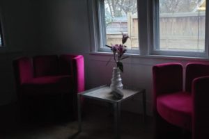 sitting area with red furniture in a dark room